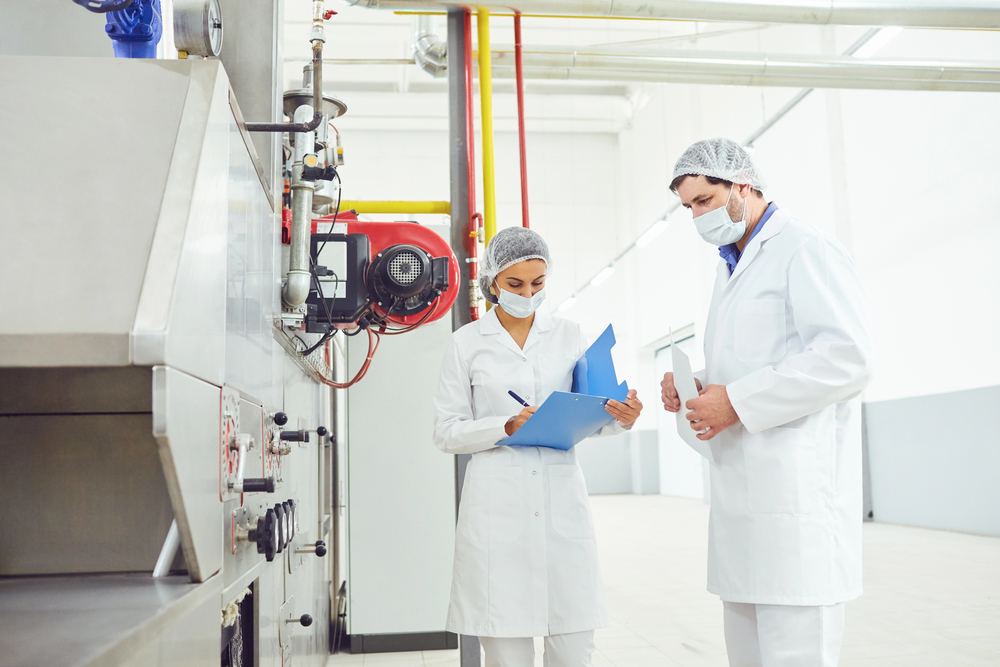 Food safety team reviewing traceability records together in a processing facility